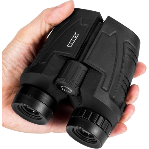compact black binoculars in being held in one hand