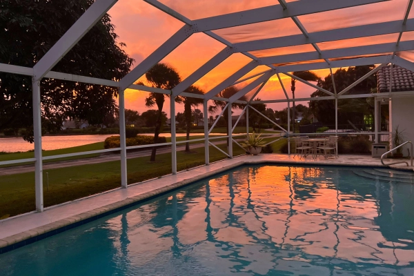 living in Florida your view is a pink and orange sunset with pool and screened in patio
