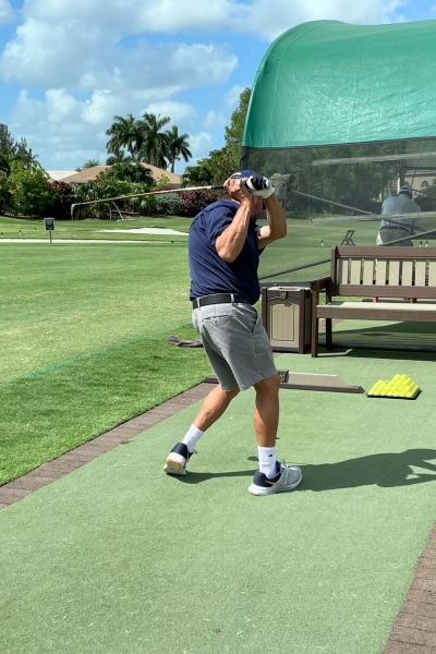 Man midswing on Golf Course in Boca Raton Florida