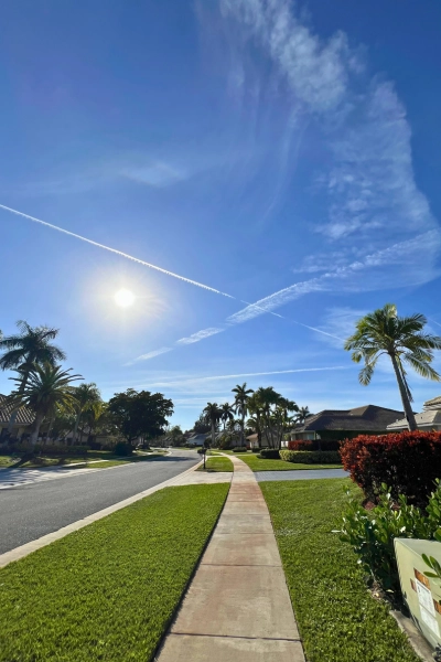 Scenic view sunny sky in residential neighborhood in Boca Raton Florida where sunscreen is an essential every Florida home needs