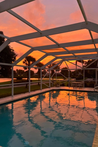 Vibrant sunset in Boca Raton Florida view from local Florida living pool and screenroom
