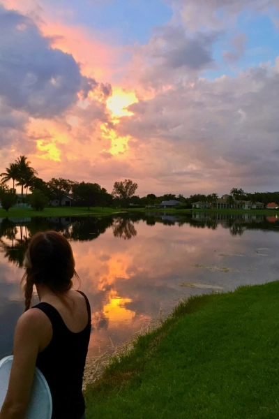 woman looking at sunset over lake in Boca Raton Florida