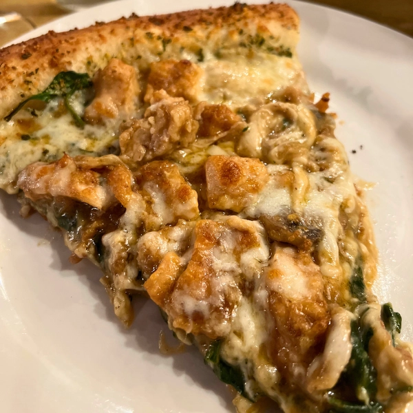 Photo of close up slice of Chicken marsala pizza a one of a kind local favorite in South Florida at Pizza Time Caffe in Parkland