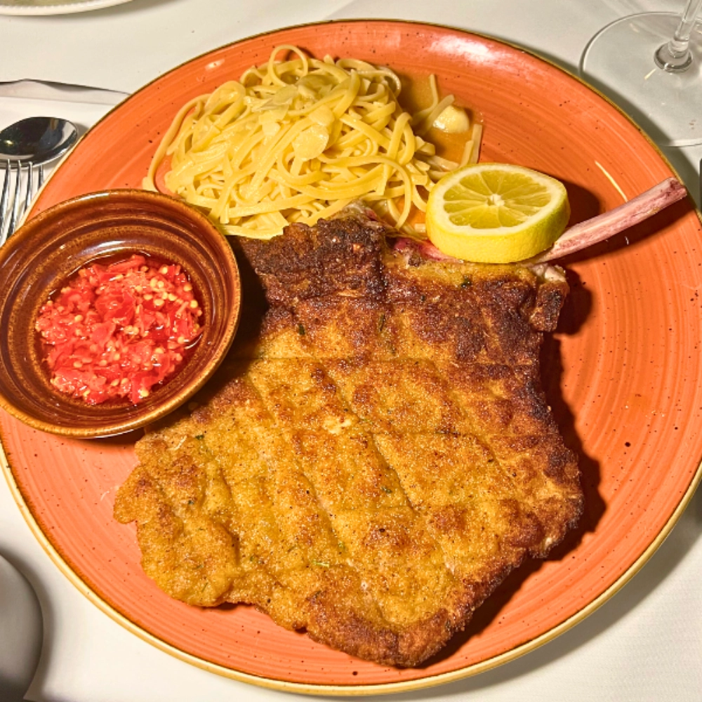 Top food and drink in South Florida at Pasta And Pork Schnitzel special with linguine on red plate is the best
