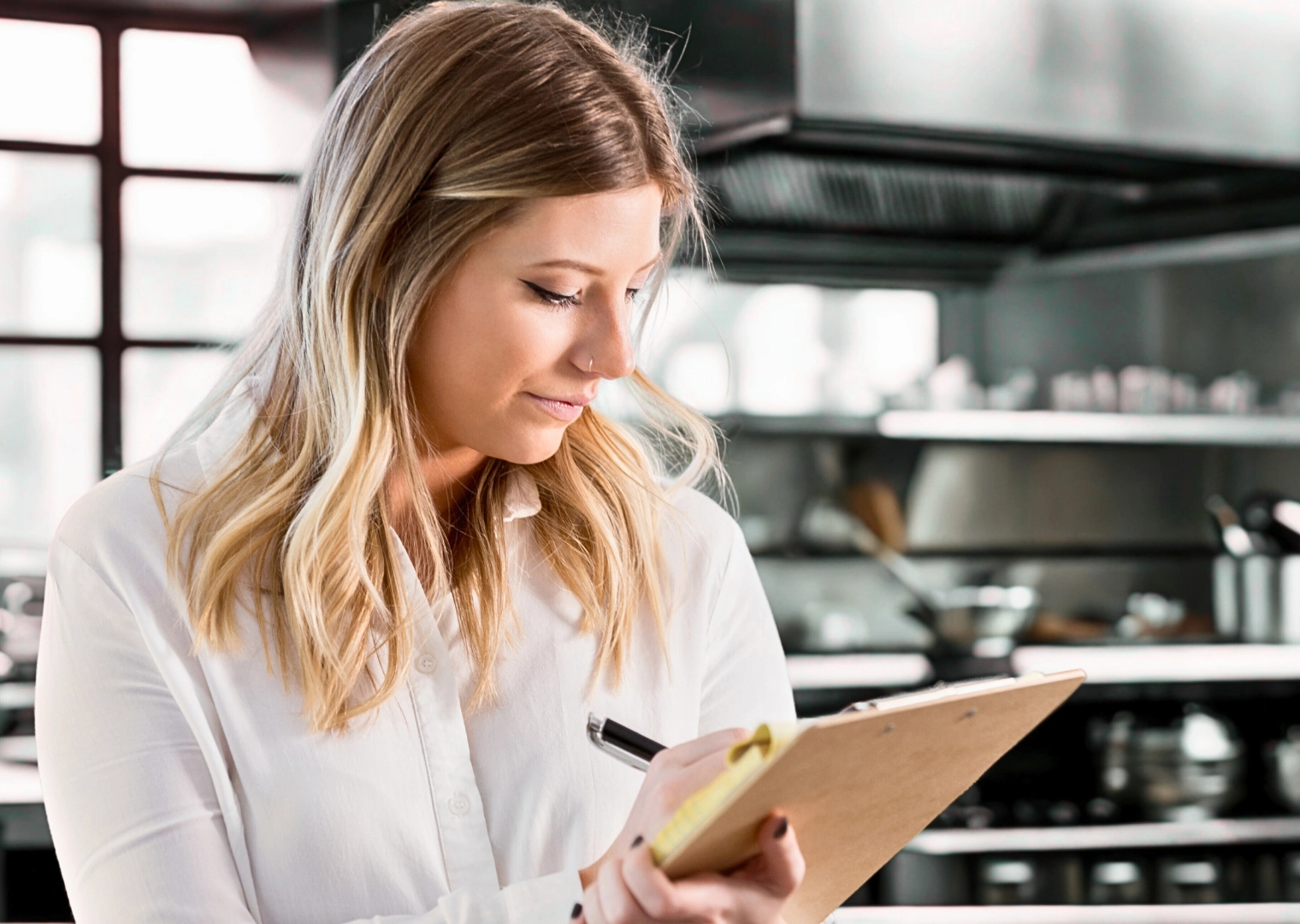Health inspector at restaurant in South Florida writing Inspection notes for Florida Restaurant Health Scores on notepad