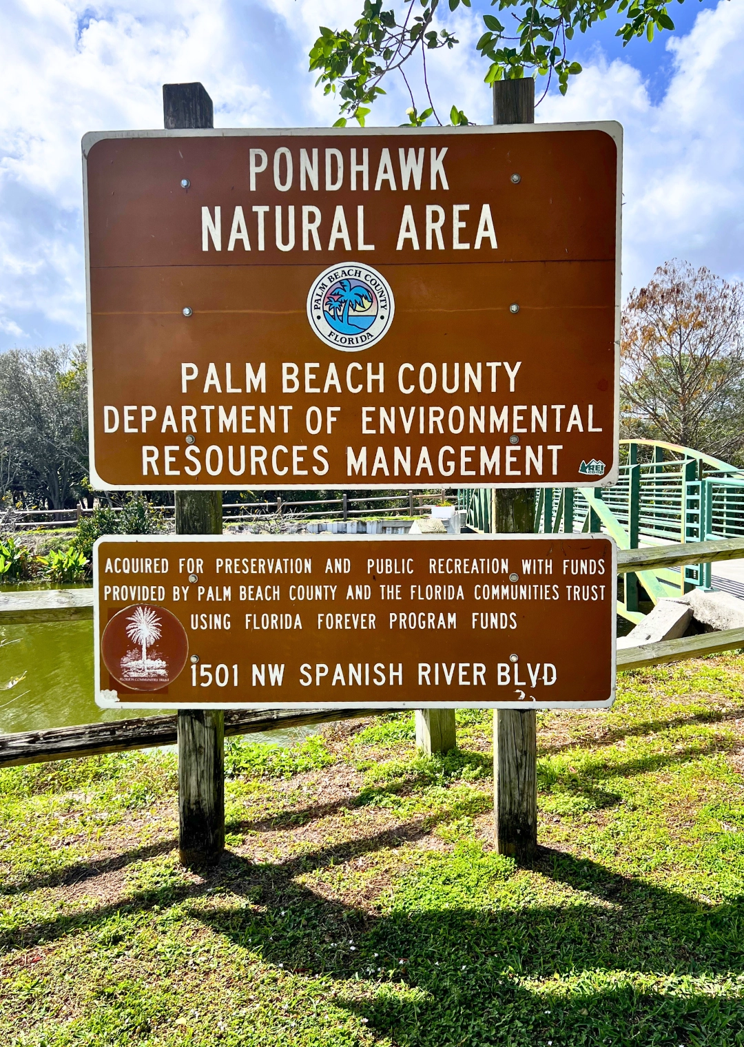 Pondhawk Natural Area Official Palm Beach County Sign in front of bridge in Boca Raton Florida