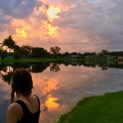 woman looking at sunset over lake in Boca Raton Florida